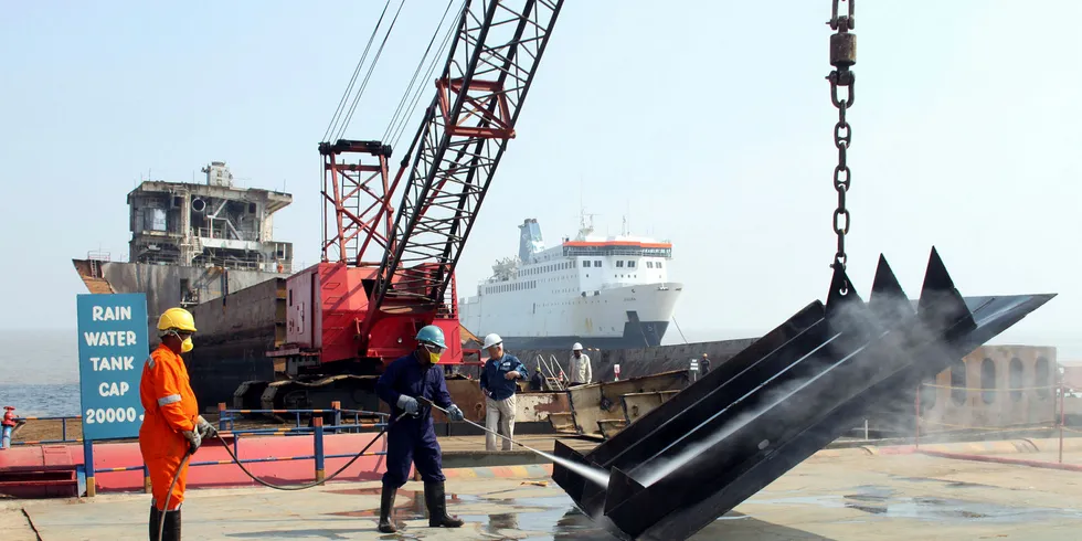 A steel plate is cleaned before being cut up at Shree Ram Vessel Scrap in Alang, India